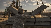 U.S. Army Reserve and U.S. Army National Guard Soldiers work together to move building materials during Resolute Castle 17 at Cincu, Romania, July 15, 2017. These Soldiers are helping complete the construction of a training facility that will be used by Allied forces the opportunity to prepare for potential conflict. The entire operation is led by U.S. Army Reserve engineers, who moved Soldiers and equipment from the U.S. to Romania over a period of several weeks to complete the training facility. Resolute Castle improves interoperability, enhances confidence and security assurance between partner nations, while improving infrastructure, capability and capacity at select locations throughout Europe. (U.S. Army Reserve photo by Staff Sgt. Felix R. Fimbres)