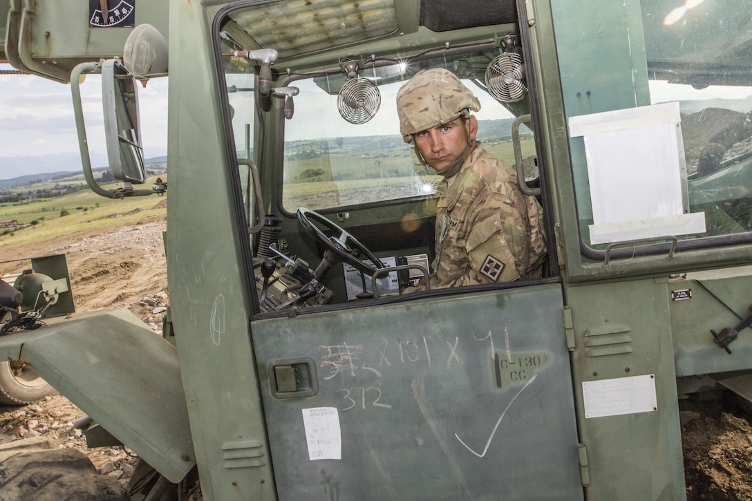 U.S. Army Reserve Soldier, Spc. Jonathan Baughn, 926th Engineer Battalion, Birmingham, Ala., uses construction equipment to move materials during Resolute Castle 17 at Cincu Romania, July 15, 2017. Baugh, a Rough Framer for Cavalier Homes, has traveled from his home in Jasper, Al., with his unit to help complete construction of a new training facility that will provide Allied forces the opportunity to prepare for potential conflict. The entire operation is led by U.S. Army Reserve engineers, who moved Soldiers and equipment from the U.S. to Romania over a period of several weeks to complete the training facility. Resolute Castle improves interoperability, enhances confidence and security assurance between partner nations, while improving infrastructure, capability and capacity at select locations throughout Europe. (U.S. Army Reserve photo by Staff Sgt. Felix R. Fimbres)