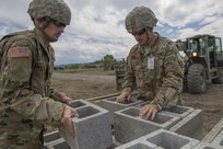 U.S. Army Reserve Soldiers Sgt. Travis Snelson, left, and Sgt. Byron Haynes, 733rd Engineer Company, Greenville, Tenn., prepare cinder blocks for transportation to another site during Resolute Castle 17, at Cincu, Romania, July 15, 2017. Snelson, who owns a landscaping company in Asheville, N.C., and Haynes, who is a highway inspector for the State of South Carolina as a contractor, are helping complete the construction of a training facility that will be used by allied forces throughout Europe. The entire operation is led by U.S. Army Reserve engineers, who moved Soldiers and equipment from the U.S. to Romania over a period of several weeks to complete the training facility. Resolute Castle improves interoperability, enhances confidence and security assurance between partner nations, while improving infrastructure, capability and capacity at select locations throughout Europe. (U.S. Army Reserve photo by Staff Sgt. Felix R. Fimbres)
