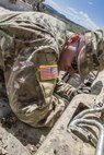 Pfc. Tyler Hutson, 390th Engineer Company, Chatanooga, Tenn., cleans the tracks of construction equipment to prevent breakdowns during Resolute Castle 17 at Cincu, Romania, July 15, 2017. Hutson, who works in the Garden Center at Walmart and lives in Dandridge, Tenn., traveled to Romania with his unit to help complete construction of a new training facility that will provide Allied forces the opportunity to prepare for potential conflict. The entire operation is led by U.S. Army Reserve engineers, who moved Soldiers and equipment from the U.S. to Romania over a period of several weeks to complete the training facility. Resolute Castle improves interoperability, enhances confidence and security assurance between partner nations, while improving infrastructure, capability and capacity at select locations throughout Europe. (U.S. Army Reserve photo by Staff Sgt. Felix R. Fimbres)