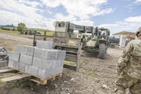 U.S. Army Reserve Soldier, Sgt. Travis Snelson, Asheville, N.C., 733rd Engineer Company Greenville, S.C., uses construction equipment to move a pallet of cinder blocks during Resolute Castle 17 at Cincu, Romania, July 15, 2017. Snelson, who owns a landscaping company in Asheville, N.C, traveled to Romania with his unit to help complete construction of a new training facility that will provide Allied forces the opportunity to prepare for potential conflict. The entire operation is led by U.S. Army Reserve engineers, who moved Soldiers and equipment from the U.S. to Romania over a period of several weeks to complete the training facility. Resolute Castle improves interoperability, enhances confidence and security assurance between partner nations, while improving infrastructure, capability and capacity at select locations throughout Europe. (U.S. Army Reserve photo by Staff Sgt. Felix R. Fimbres)