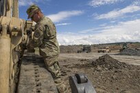 Pfc. Tyler Hutson, 390th Engineer Company, Chatanooga, Tenn., cleans the tracks of construction equipment to prevent breakdowns during Resolute Castle 17 at Cincu, Romania, July 15, 2017. Hutson, who works in the Garden Center at Walmart and lives in Dandridge, Tenn., traveled to Romania with his unit to help complete construction of a new training facility that will provide Allied forces the opportunity to prepare for potential conflict. The entire operation is led by U.S. Army Reserve engineers, who moved Soldiers and equipment from the U.S. to Romania over a period of several weeks to complete the training facility. Resolute Castle improves interoperability, enhances confidence and security assurance between partner nations, while improving infrastructure, capability and capacity at select locations throughout Europe. (U.S. Army Reserve photo by Staff Sgt. Felix R. Fimbres)