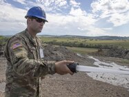 U.S. Army Reserve Soldier, Spc. Jordy Hall, 390th Engineer Company, Chattanooga, Tenn., washes down construction equipment, part of routine maintenance, during Resolute Castle 17 at Cincu, Romania, July 15, 2017. Hall, who works at a Walmart Distribution Center, Greenville, Tenn., has traveled from his home in Greenville, Tenn., with his unit to help complete construction of a new training facility that will provide Allied forces the opportunity to prepare for potential conflict. The entire operation is led by U.S. Army Reserve engineers, who moved Soldiers and equipment from the U.S. to Romania over a period of several weeks to complete the training facility. Resolute Castle improves interoperability, enhances confidence and security assurance between partner nations, while improving infrastructure, capability and capacity at select locations throughout Europe. (U.S. Army Reserve photo by Staff Sgt. Felix R. Fimbres)
