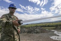 U.S. Army Reserve Soldier, Spc. Jordy Hall, 390th Engineer Company, Chattanooga, Tenn., washes down construction equipment, part of routine maintenance, during Resolute Castle 17 at Cincu, Romania, July 15, 2017. Hall, who works at a Walmart Distribution Center, Greenville, Tenn., has traveled from his home in Greenville, Tenn., with his unit to help complete construction of a new training facility that will provide Allied forces the opportunity to prepare for potential conflict. The entire operation is led by U.S. Army Reserve engineers, who moved Soldiers and equipment from the U.S. to Romania over a period of several weeks to complete the training facility. Resolute Castle improves interoperability, enhances confidence and security assurance between partner nations, while improving infrastructure, capability and capacity at select locations throughout Europe. (U.S. Army Reserve photo by Staff Sgt. Felix R. Fimbres)