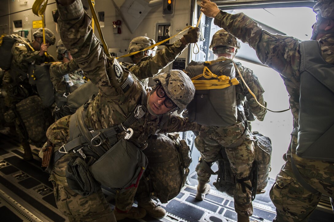 A U.S. Army airborne jumpmaster from the 4th Brigade, 25th Infantry Division, watches for the green light above the troop door on an U.S. Air Force C-17 Globemaster III, which signals that the aircraft has reached the drop zone, during exercise Talisman Saber over Australia, July 12, 2017. Air Force photo by Tech. Sgt. Gregory Brook