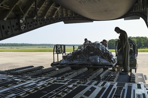 Aerial porters from the 19th Logistics Readiness Squadron load cargo onto a C-17 Globemaster July 23, 2017, at Little Rock Air Force Base, Ark. More than 100 Team Little Rock members will lead, coordinate and execute maintenance operations during Mobility Guardian 2017. The exercise will test each of Air Mobility Command’s core competencies including airlift, aerial refueling, aeromedical evacuation and mobility support operations. (U.S. Air Force photo by Staff Sgt. Harry Brexel)