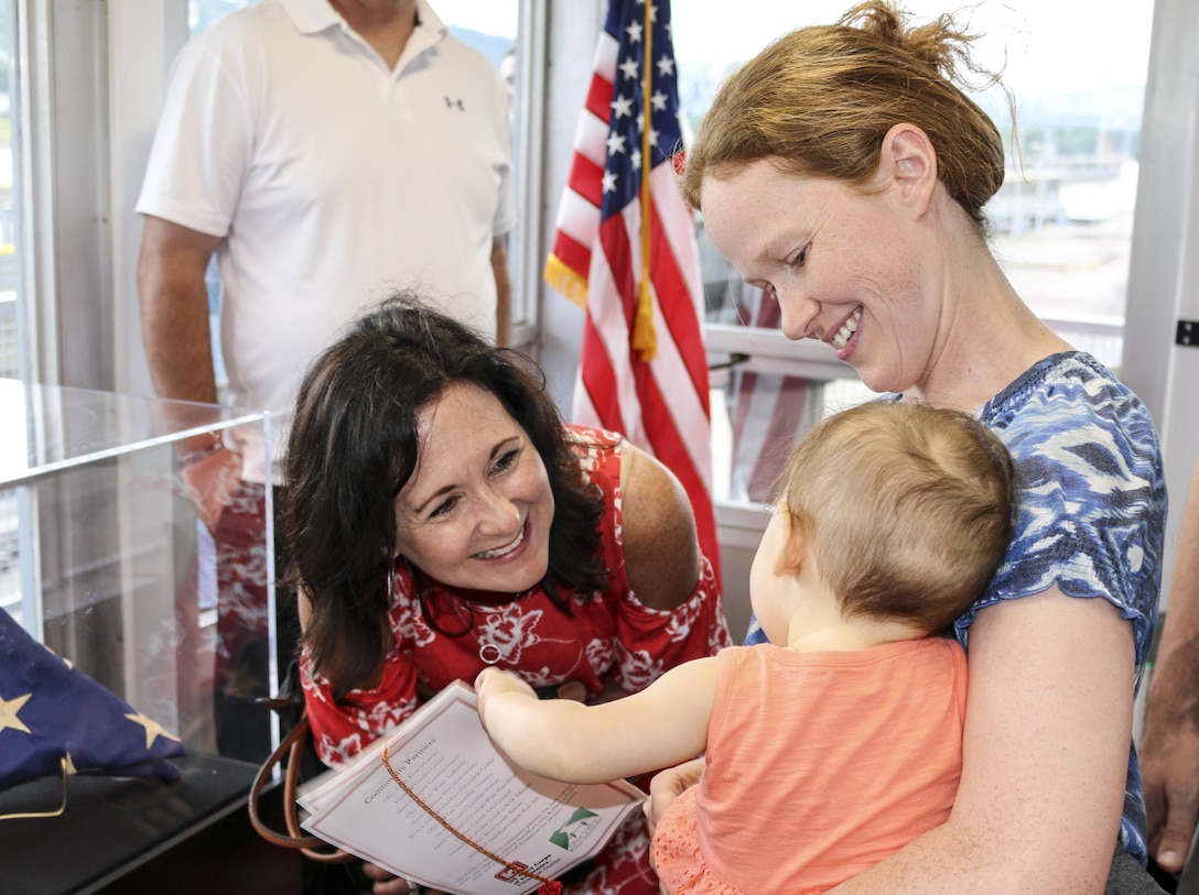 Stacy Lloyd, district commander's wife, greets one of the youngest visitors at the Hannibal Lock and Dam visitor’s center, July 1.
