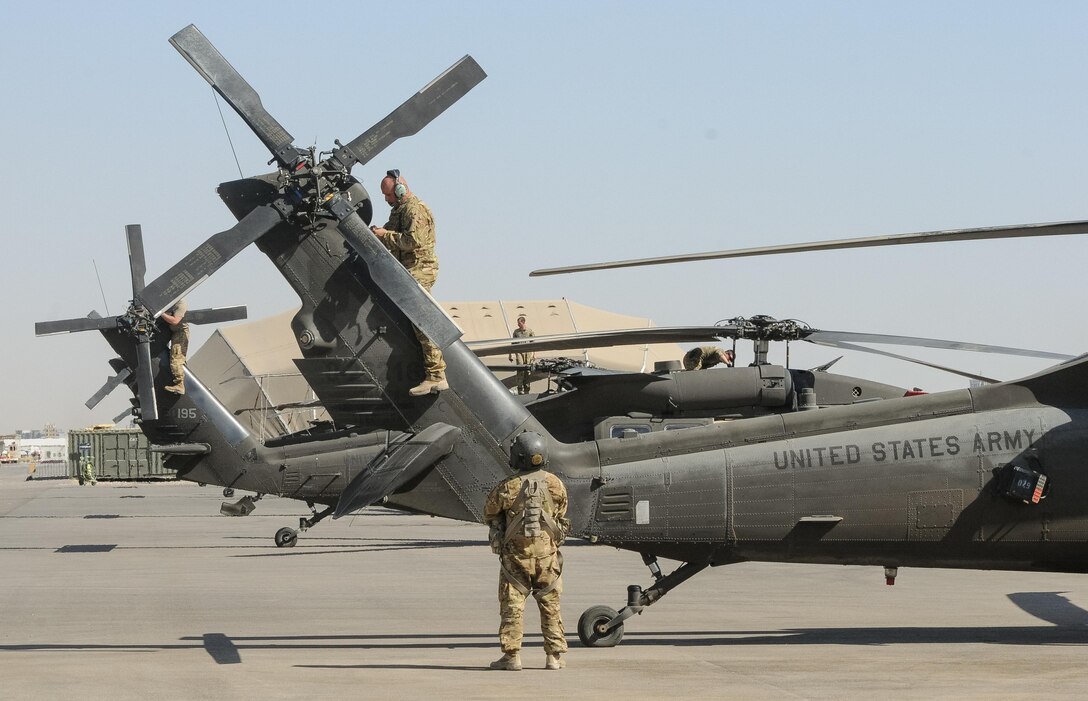 ERBIL, Iraq – Crew chiefs assigned to B Company,2-149th General Support Aviation Battalion, Task Force Saber, conduct post-flight inspections on UH-60M Black Hawk helicopters at Erbil, Iraq, July 11,2017. The UH-60M Black Hawk provides Task Force Saber the capability to conduct distinguished visitor movement, logistical movement and aeromedical evacuation throughout the area of operations for Task Force Saber and Combined Joint Task Force – Operation Inherent Resolve. CJTF-OIR is the Coalition to defeat ISIS in Iraq and Syria. (U.S. Army photo by Capt. Stephen James)