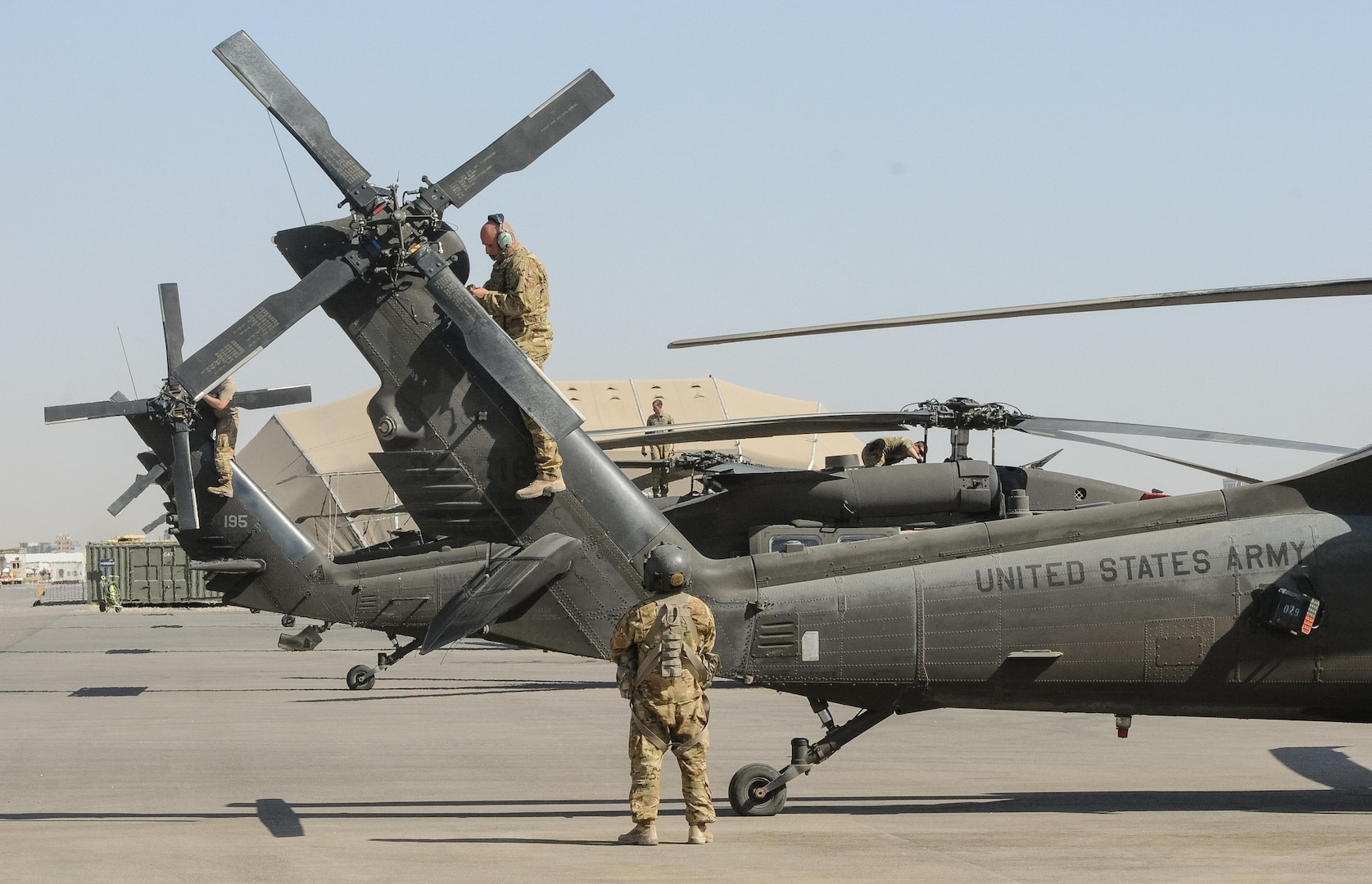 ERBIL, Iraq – Crew chiefs assigned to B Company,2-149th General Support Aviation Battalion, Task Force Saber, conduct post-flight inspections on UH-60M Black Hawk helicopters at Erbil, Iraq, July 11,2017. The UH-60M Black Hawk provides Task Force Saber the capability to conduct distinguished visitor movement, logistical movement and aeromedical evacuation throughout the area of operations for Task Force Saber and Combined Joint Task Force – Operation Inherent Resolve. CJTF-OIR is the Coalition to defeat ISIS in Iraq and Syria. (U.S. Army photo by Capt. Stephen James)