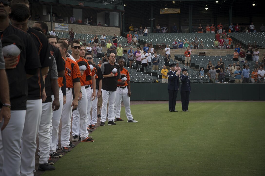 Master Sgt. David Wagstaff, 1st Airlift Squadron communications system operator, and Staff Sgt. Sarah Wagstaff, 89th Operations Support Squadron analyst, sing the national anthem during Joint Base Andrews Military Appreciation Night hosted by the Bowie Baysox at Prince George’s Stadium, in Bowie, Md., July 21, 2017. Several military members participated in opening ceremonies including the presenting of the colors, singing the national anthem, and throwing out the ceremonial first pitch.(U.S. Air Force photo by Senior Airman Mariah Haddenham)