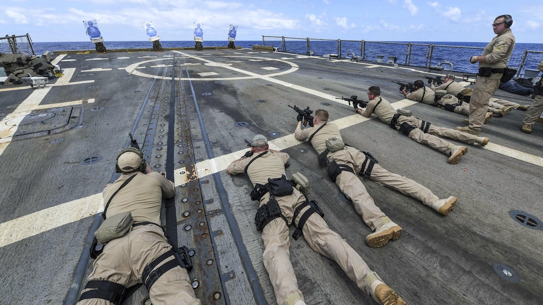 Sailors fire weapons as they participate in a visit, board, search and seizure team qualification on the USS James E. Williams in the Atlantic Ocean, July 21, 2017. The Williams is deployed to the U.S. 6th Fleet area of operations to support U.S. national security interests in Europe. Navy photo by Petty Officer 3rd Class Colbey Livingston