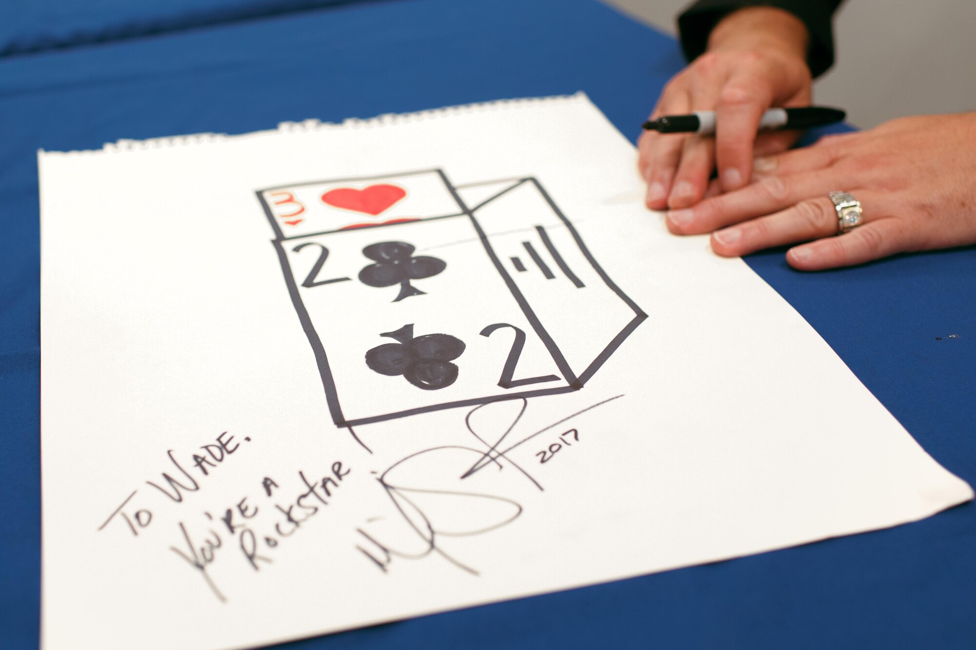 Mike Super signs a drawing for a fan during a meet and greet at Joint Base Andrews, Md., July 21, 2017. Throughout the summer, Super will share his magic with audiences during his 17-installation tour, which launched July 20 at Dover Air Force Base, Del. (U.S. Air Force photo by Senior Airman Delano Scott)