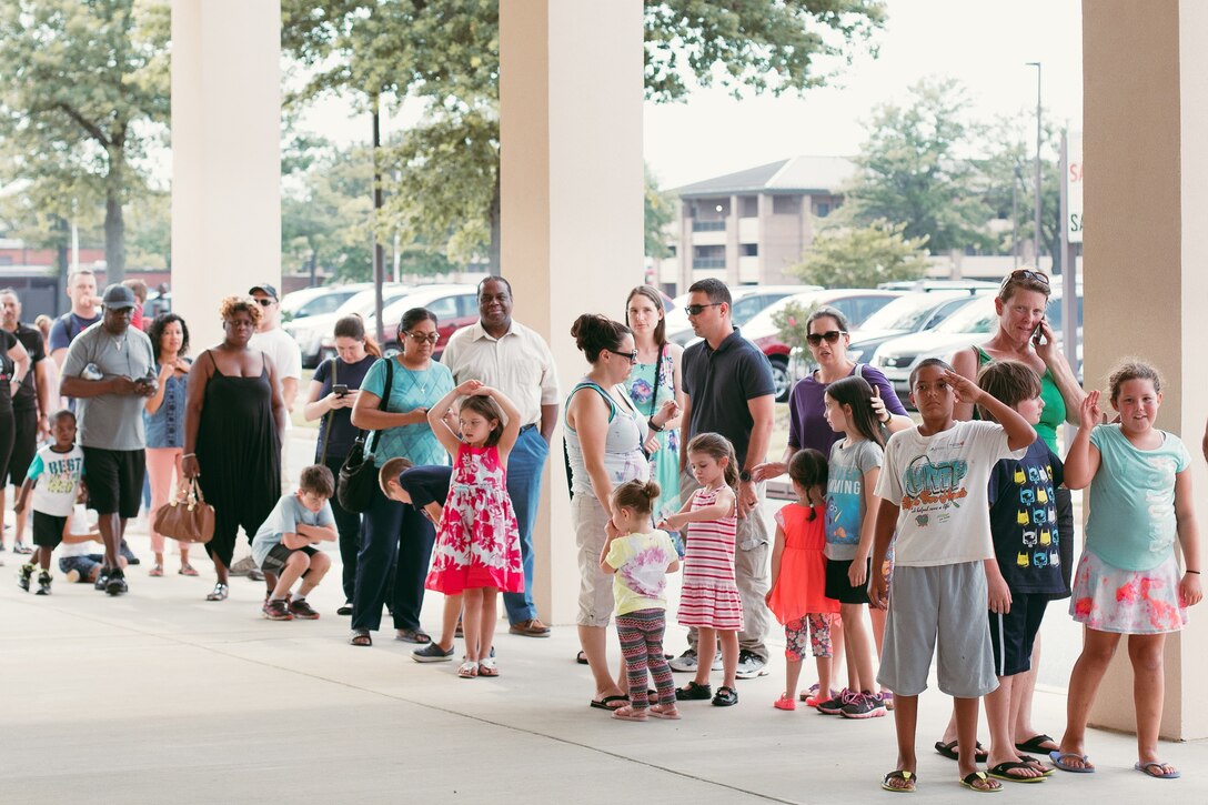 Audience members line up prior to the start of the Mike Super Magic and Illusion show at Joint Base Andrews, Md., July 21, 2017. The 11th Force Support Squadron and the Air Force Services Activity’s ‘Live Stage’ entertainment program came together in a combined effort to bring entertainment to Airmen and their families. (U.S. Air Force photo by Senior Airman Delano Scott)