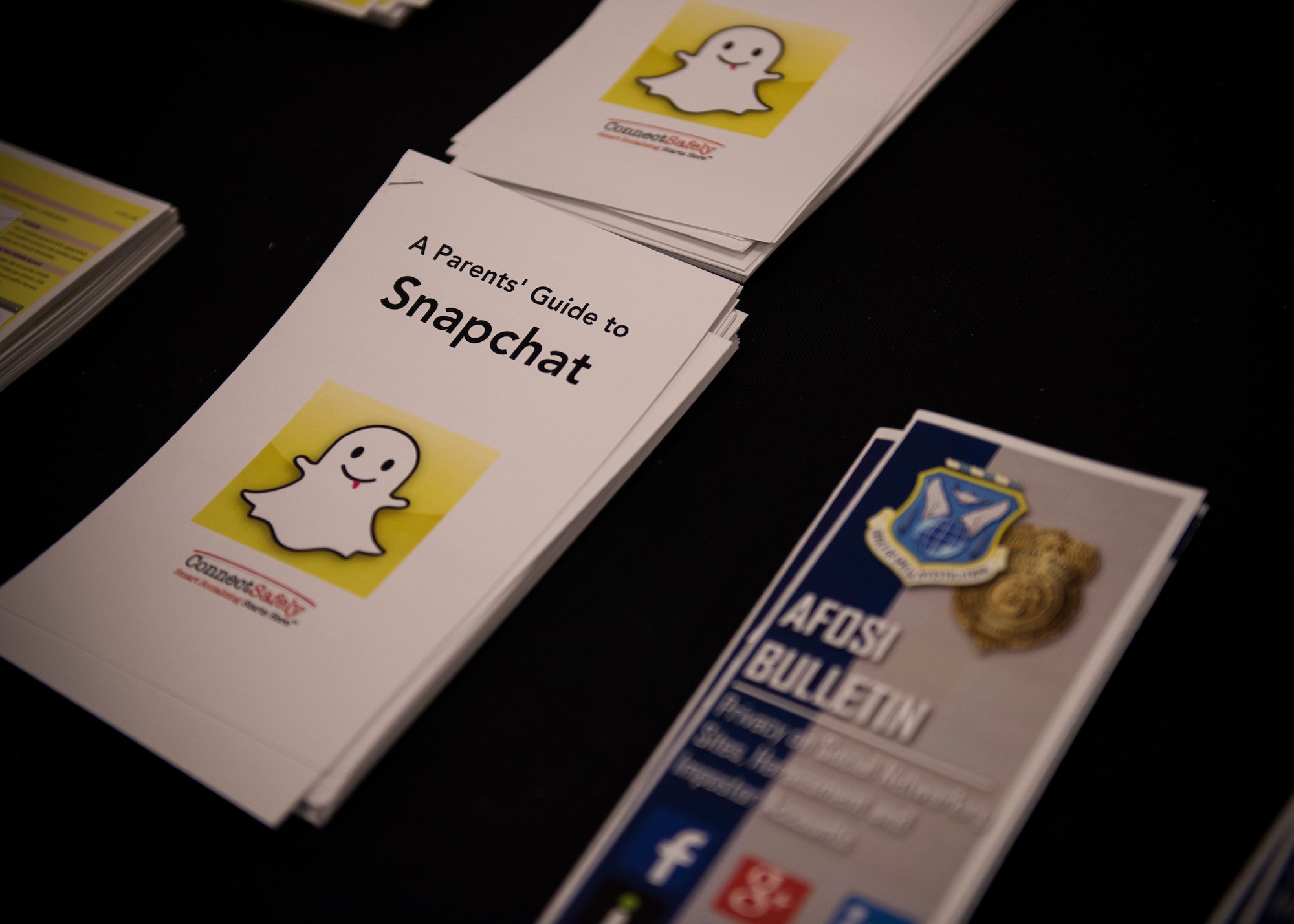 A stack of social media information flyers sit at the Operation Security booth at Eglin Air Force Base, Fla. July 20. The purpose of the flyers was to educate base families about how to safely connect on-line while protecting sensitive and personally identifiable information. (U.S. Air Force photo/Ilka Cole)