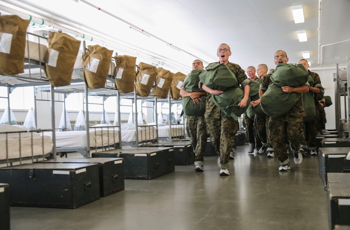 Recruits from India Company, 3rd Recruit Training Battalion, rush to get on line during pick up at Marine Corps Recruit Depot San Diego, July 21. Recruits are taught by their drill instructors to get on line, which means to stand in front of their footlockers. Annually, more than 17,000 males recruited from the Western Recruiting Region are trained at MCRD San Diego. India Company is scheduled to graduate Oct. 13.