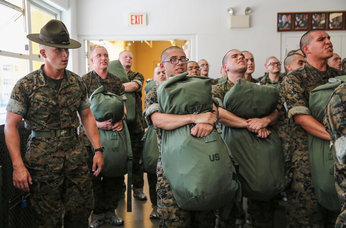 Recruits from India Company, 1st Recruit Training Battalion, hold their sea bags during pick up at Marine Corps Recruit Depot San Diego, July 21. Drill instructors ensure that the recruits fill their bags with the appropriate items and that extra gear is emptied into the recruit’s footlocker. Annually, more than 17,000 males recruited from the Western Recruiting Region are trained at MCRD San Diego. India Company is scheduled to graduate Oct. 13.