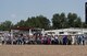 Members of the military and local community transport the American flag into Frontier Park arena during Military Monday in Cheyenne, Wyo., July 24, 2017. The flag presentation is an annual tradition at Cheyenne Frontier Days. This year marks the 150th anniversary of F.E. Warren Air Force Base and the city of Cheyenne. The two communities came together to celebrate during the 121st CFD rodeo and festival. (U.S. Air Force photo by Staff Sgt. Christopher Ruano)