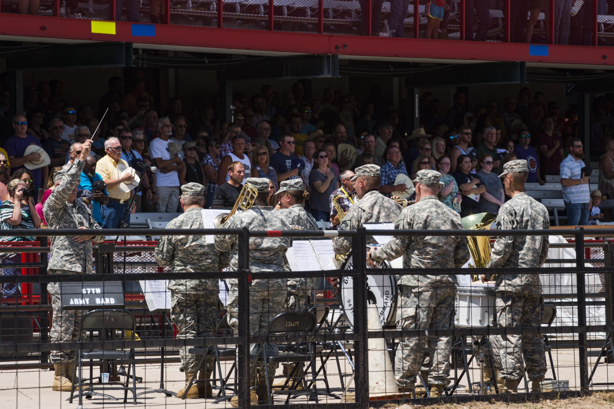 The 67th Army Band, Wyoming National Guard, plays the national anthem during Military Monday at Frontier Park in Cheyenne, Wyo., July 24, 2017. While the anthem played, more than 100 volunteers unfurled a massive flag to begin the rodeo’s grand entry ceremony. This year marks the 150th anniversary of F.E. Warren Air Force Base and the city of Cheyenne. The two communities came together to celebrate during the 121st Cheyenne Frontier Days rodeo and festival. (U.S. Air Force photo by Staff Sgt. Christopher Ruano)
