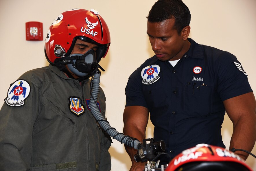 Staff Sgt. Kyle Boddie, U.S. Air Force Thunderbirds aircrew flight equipment technician, tests Juan Alonzo’s breathing in a flight helmet before his flight July 24, 2017, on the Wyoming Air National Guard Base, Cheyenne, Wyo. The pilot and occupant are given a safety brief before the flight to ensure they are prepared for flight and can handle an in-flight emergency. (U.S. Air Force photo by 2d Lt. Nikita Thorpe)