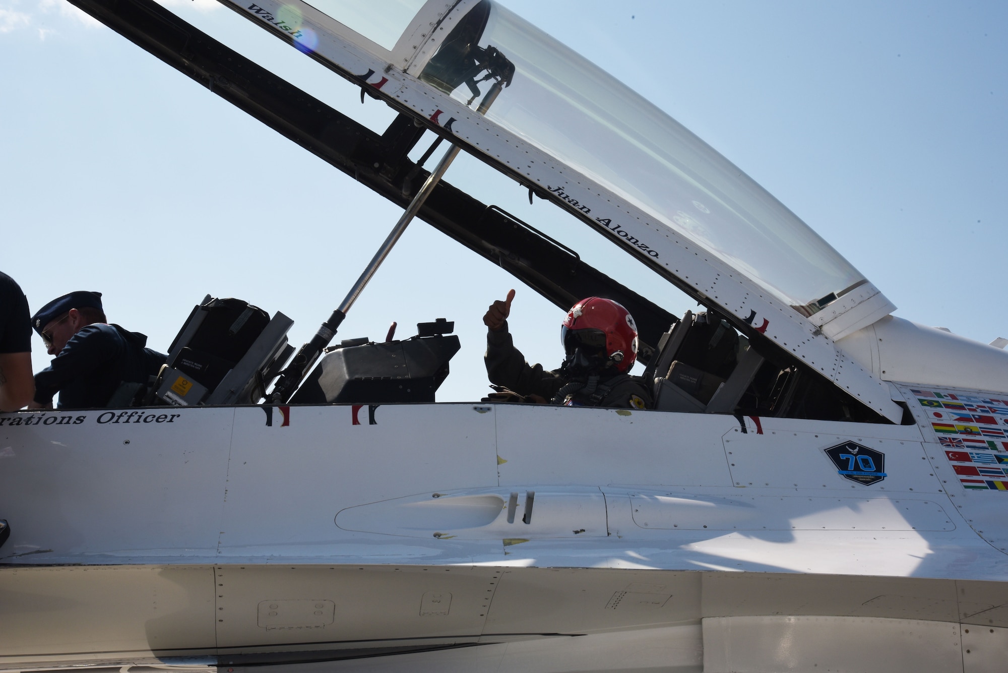 Juan Alonzo gives a thumbs-up from the U.S. Air Force Thunderbirds F-16 Fighting Falcon fighter aircraft before his flight July 24, 2017, on the Wyoming Air National Guard Base, Cheyenne, Wyo. Alonzo is a U.S. Army veteran and Championship Bull Rider competing in the World Finals during the 2017 Cheyenne Frontier Days. (U.S. Air Force photo by 2d Lt. Nikita Thorpe)