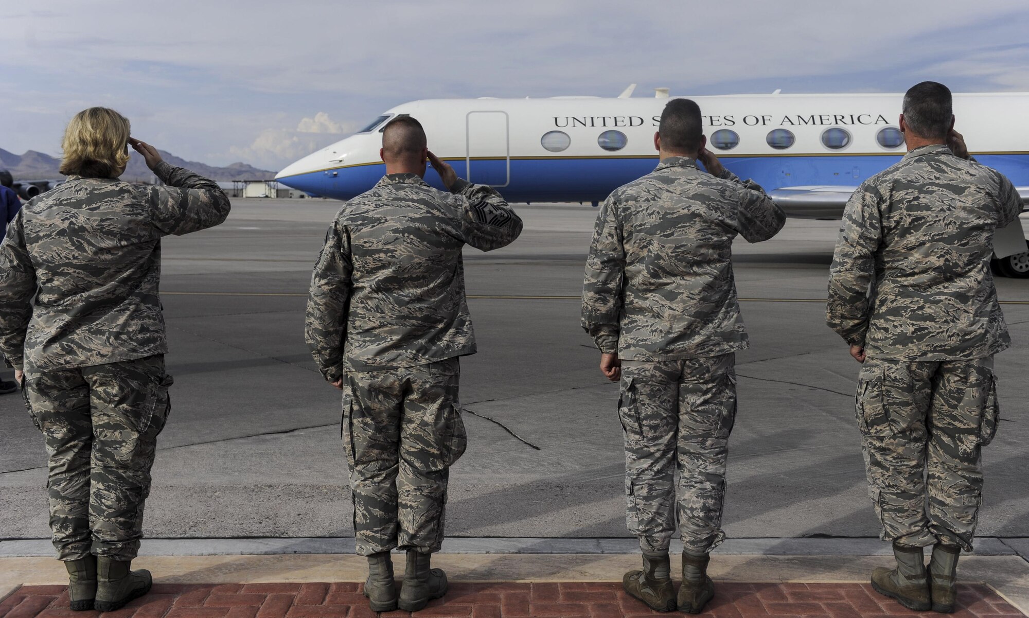 Leaders from the United States Warfare Center salute the jet of Secretary of the Air Force Heather Wilson as it arrives at Nellis Air Force Base, Nevada, July 17, 2017. Wilson witnessed firsthand how Airmen at Red Flag are training through innovation. (U.S. Air Force photo by Senior Airman Kevin Tanenbaum)