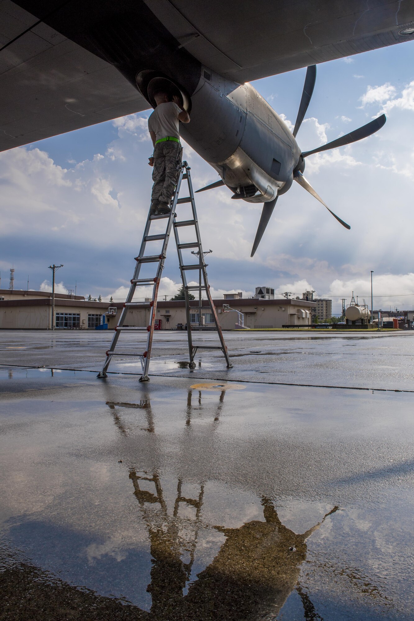 An Airman with the 374th Operations Group performs preflight checks on a C-130J Super Hercules engine exhaust system, July 18, 2017, at Yokota Air Base, Japan. Pre-flight checks are done before takeoff to ensure aircraft are ready for flight. (U.S. Air Force photo by Airman 1st Class Donald Hudson)