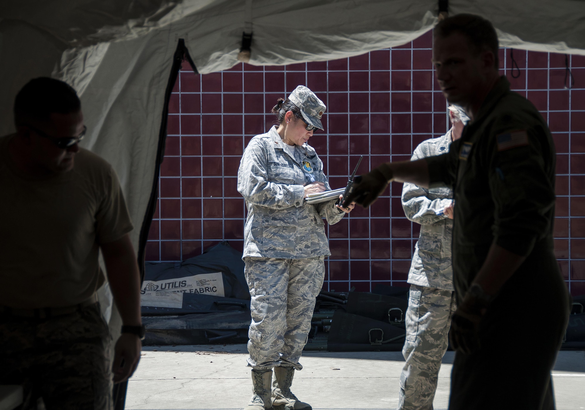 Maj. Theresa Sun-Isbell, 349th Aeromedical Staging Squadron wing inspection team lead, observes members of the ASTS partake in a humanitarian aid scenario as part of Patriot Wyvern at Travis Air Force Base, Cali., on July 22, 2017. The 349th ASTS members had one hour to set up an En-Route Patient Staging Facility and communications. They accomplished their task in less than 30 minutes. (U.S. Air Force photo by Staff Sgt. Daniel Phelps)