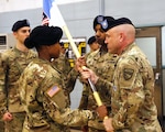 Lt. Col. Jay Land, former United States Forces Korea Special Troops Battalion commander, hands the guidon to Capt. Fairusa Adams, commander of USFK Support Company during a ceremony at United States Army Garrison Yongasan, July 21. The USC is taking the place of the STB and will have administrative control of 8th Army HHB supporting approximately 350 USFK service members.
