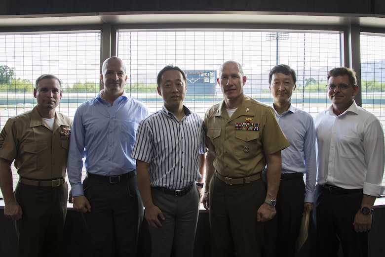 From left to right: U.S. Marine Corps Sgt. Maj. Christopher J. Garza, sergeant major of Marine Corps Air Station (MCAS) Iwakuni, Brian Wottowa, director of Integrated Program Management Office with the Defense Policy Review Initiative, Yoshihiko Fukuda, mayor of Iwakuni City, U.S. Marine Corps Col. Richard F. Fuerst, commanding officer of MCAS Iwakuni, Takahiro Sugawara, director general of Chugoku-Shikoku Defense Bureau, and John Lackie, deputy director of IPMO with DPRI, pose for a photo during a tour of Kizuna Stadium in Iwakuni City, Japan, July 19, 2017.  Joint efforts between MCAS Iwakuni personnel, the locals of Iwakuni City and Fukuda have led to the upcoming completion of the stadium for U.S. service members, their families and local Japanese.  (U.S. Marine Corps photo by Cpl. Joseph Abrego)