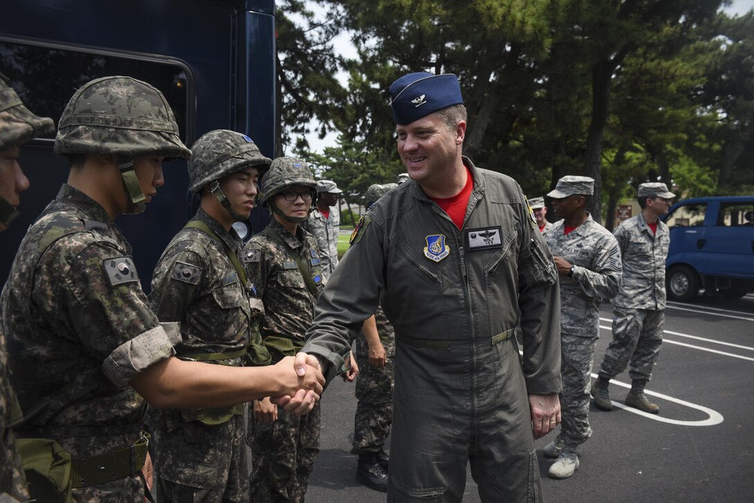 U.S. Air Force Col. David Shoemaker, 8th Fighter Wing commander, greets Republic of Korea Air Force personnel before a joint hazardous material training scenario at Kunsan Air Base, ROK, July 21, 2017. The 8th Civil Engineer Squadron readiness and emergency management flight hosted the training scenario, which educated participants on HAZMAT response equipment and operations. (U.S. Air Force photo by Senior Airman Michael Hunsaker/ Released)