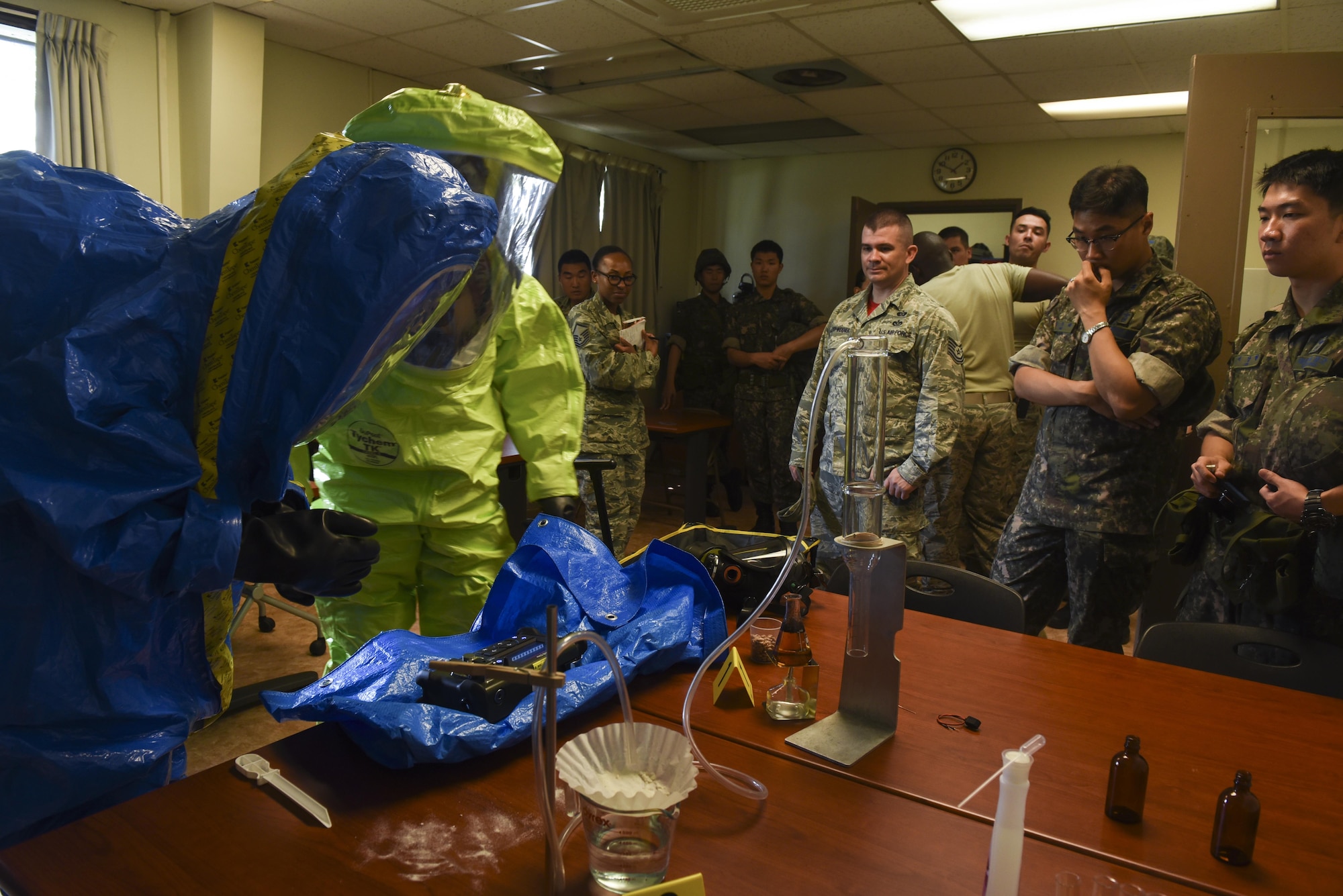 Republic of Korea Air Force members watch as 8th Civil Engineer Squadron readiness and emergency management flight Airmen perform tests to identify an unknown substance in a training scenario at Kunsan Air Base, Republic of Korea, July 21, 2017. The training gave members a better understanding of hazardous material response equipment and operations. (U.S. Air Force photo by Senior Airman Michael Hunsaker/ Released)