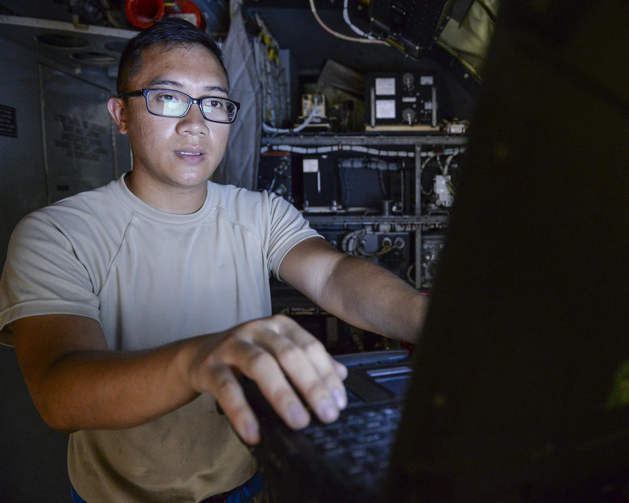 U.S. Air Force Senior Airman Tony Nguyen, guidance and control journeyman assigned to the 340th Expeditionary Aircraft Maintenance Unit, reviews a technical order before replacing a power control relay on a KC-135 Stratotanker at Al Udeid, Air Base, Qatar, July 7, 2017. The members of the 340th and 22nd EAMUs face minute-by-minute challenges in the sweltering heat on the runway as they work to keep a fleet of KC-135 Stratotankers ready to fly. (U.S. Air National Guard photo by Tech. Sgt. Bradly A. Schneider/Released)