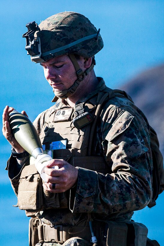 Marine Corps Sgt. William Fabrocini holds an 81 mm mortar shell that will soon be fired during Exercise Talisman Saber 17 at Townshend Island, Shoalwater Bay Training Area, Australia, July 21, 2017. Fabrocini is a mortarman assigned to Weapons Company, Battalion Landing Team, 3rd Battalion, 5th Marines. Marine Corps photo by Lance Cpl. Stormy Mendez