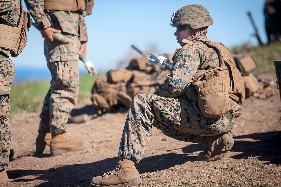 Marine Corps Lance Cpl. Hugo Gonzales prepares an 81 mm mortar shell that will soon be fired during Exercise Talisman Saber 17 at Townshend Island, Shoalwater Bay Training Area, Australia, July 21, 2017. Gonzales is a mortarman assigned to Weapons Company, Battalion Landing Team, 3rd Battalion, 5th Marines. Marine Corps photo by Lance Cpl. Stormy Mendez 