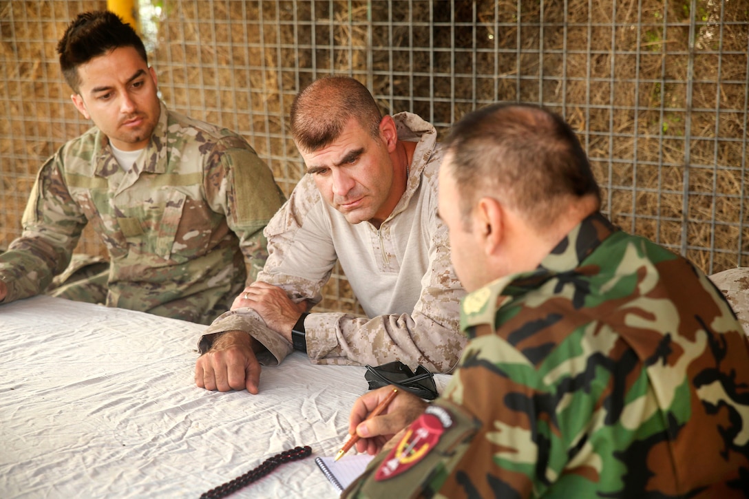 U.S. Marine Corps Col. Matthew Grosz, center, speaks with Afghan Army Brig. Gen. Ahmadzai, right, commander, of the 215th Corps, at Camp Shorserack, Afghanistan, July 15, 2017. Marine Corps photo by Sgt. Lucas Hopkins