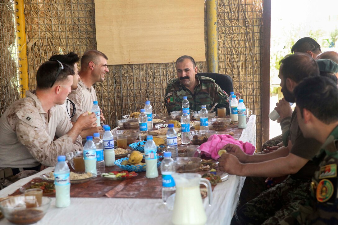 U.S. Marine Corps Col. Matthew Grosz, center left, and several of his staff members join Afghan Army Brig. Gen. Ahmadzai, commander, of the 215th Corps, to discuss strategy during Operation Maiwand Four at Camp Shorserack, Afghanistan, July 16, 2017. Marine Corps photo by Sgt. Lucas Hopkins