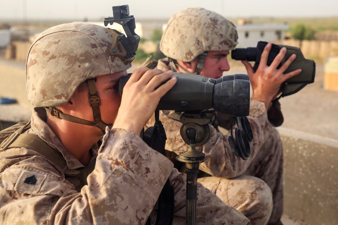 Marines use binoculars as they search for enemy activity during Operation Maiwand Four at Camp Shorserack, Afghanistan, July 17, 2017. Marine Corps photo by Sgt. Lucas Hopkins