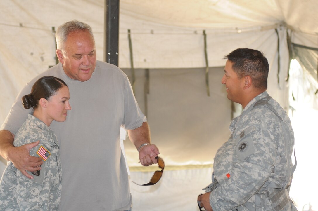 Sgt. Angela Myers, 311th ESC ammunition sergeant, chats with her Uncle Corey Rose and platoon sergeant, Sgt. 1st Class David Flores, inside her tent at CSTX.
This is Myers first time meeting her uncle or any biological family. She was raised in foster care.