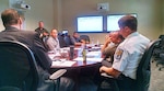 William Bullock, Sr., emergency manager, DLA Installation Support at Richmond, Virginia (standing) facilitates a hurricane emergency tabletop exercise with employees who make up the Defense Supply Center Richmond Emergency Management and Crisis Management Teams July 20, 2017. The exercise brought key installation personnel together who would work to secure the base, perform emergency communications, respond to cleanup efforts and make sure mission essential functions and aviation logistics support continue to our nation’s warfighters in the event of a hurricane or other natural disaster.