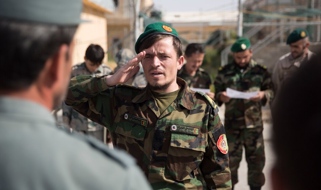 An Afghan National Army soldier steps up to receive his certificate for graduating a map reading class at Bost Airfield, Afghanistan, July 22, 2017. With assistance from U.S. Marine advisors with Task Force Southwest, the three-week course covered multiple areas including measuring straight and curved line distances, as well as being able to plot and pull a six-digit grid from a map. (U.S. Marine Corps photo by Justin T. Updegraff)