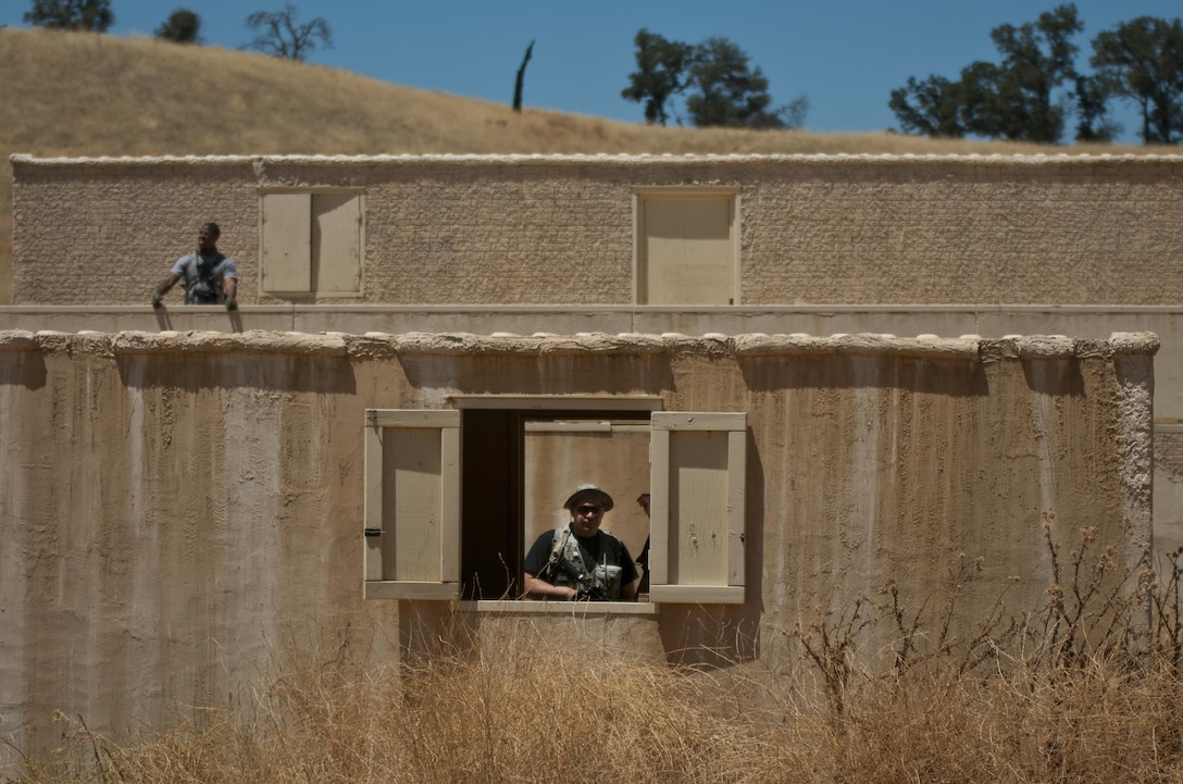 Members of the U.S. Army Reserve Command’s 96th Military Police Company, 96th Military Police Battalion, plot out which buildings and locations from which they will launch attacks against other U.S. Army Reserve Command troops while roleplaying as enemy combatants during a training exercise at Niscoln, a small mock village on Fort Hunter Liggett, Calif., July 20, 2017. The other Reserve Soldiers, members of the 344th Military Police Company, 485th Chemical Battalion, and 382nd Military Police Battalion, are undergoing training to better prepare them to deploy and win against enemy forces. Nearly 5,400 service members from the U.S. Army Reserve Command, U.S. Army, Army National Guard, U.S. Navy, and Canadian Armed Forces are training at Fort Hunter Liggett as part of the 84th Training Command’s Combat Support Training Exercise 91-17-03 and ARMEDCOM’s Global Medic; this is a unique training opportunity that allows U.S. Army Reserve units to train alongside their multi-component and joint partners as part of the America’s Army Reserve evolution into the most lethal Federal Reserve force in the history of the nation. (U.S. Army Reserve photo by Sgt. David L. Nye, 301st Public Affairs Detachment)