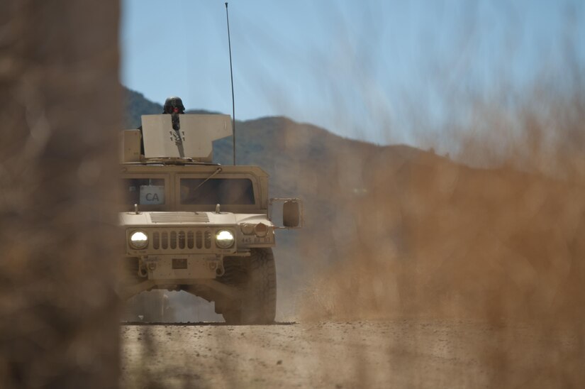 An Army Reserve Soldier pulls security in the turret of a HMMWV during training at Niscoln, a small mock village on Fort Hunter Liggett, Calif., July 20, 2017. The HMMWV was part of a convoy that soon came under attack from U.S. Army Reserve Command military police from the 96th Military Police Company, 96th Military Police Battalion, roleplaying as enemy forces during the exercise. Nearly 5,400 service members from the U.S. Army Reserve Command, U.S. Army, Army National Guard, U.S. Navy, and Canadian Armed Forces are training at Fort Hunter Liggett as part of the 84th Training Command’s CSTX 91-17-03 and ARMEDCOM’s Global Medic; this is a unique training opportunity that allows U.S. Army Reserve units to train alongside their multi-component and joint partners as part of the America’s Army Reserve evolution into the most lethal Federal Reserve force in the history of the nation. (U.S. Army Reserve photo by Sgt. David L. Nye, 301st Public Affairs Detachment)