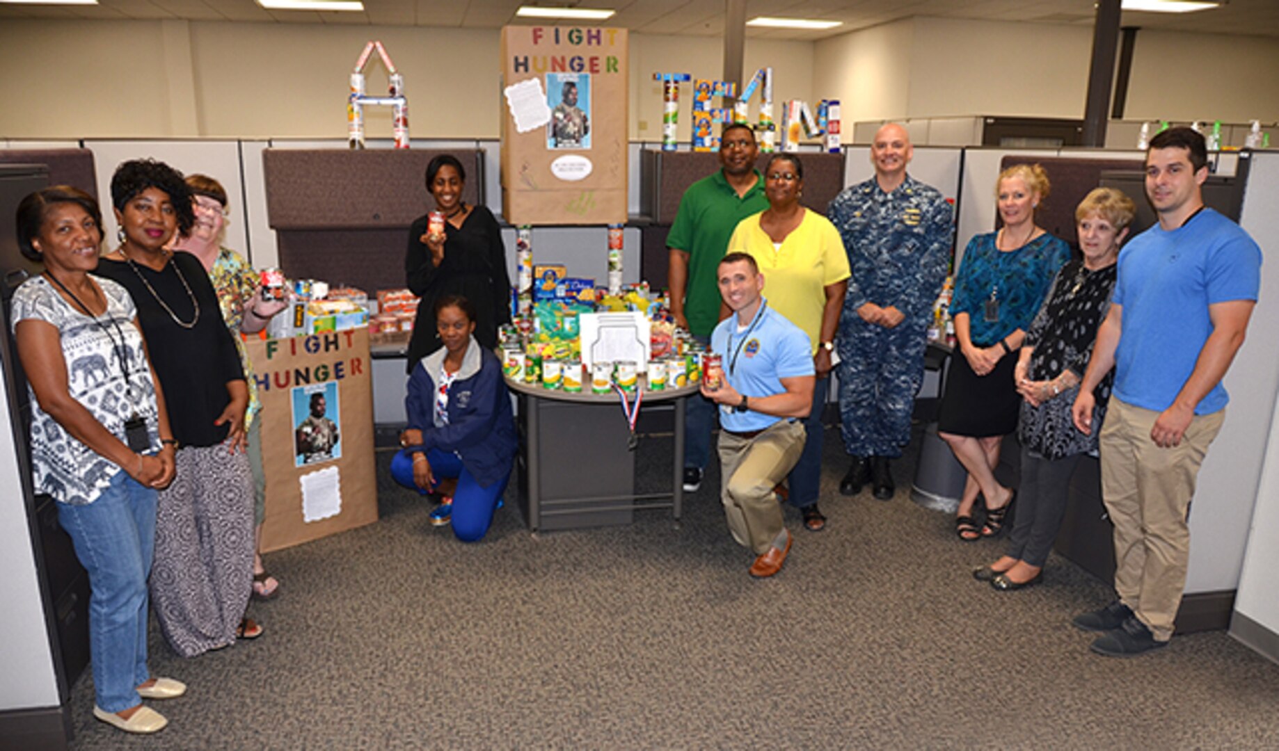 The Food Bank Team, made up of employees from DLA Aviation Supplier Operations and Planning Process Directorates, poses with their display June 7, 2017.  The temporary team, formed to build morale and comradery, collected almost 600 items for Downtown Churches United in Petersburg, Virginia. 