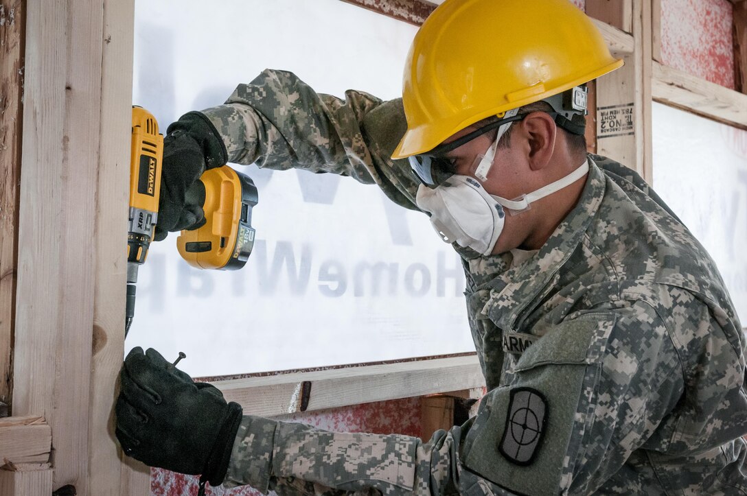 U.S. Army Reserve Spc. Alex Lopez, a carpentry and masonry specialist of the 994th Engineer Company out of Denver, Colorado, assists in the construction of a staff-member bath house at the YMCA of the Rockies - Snow Mountain Ranch, Granby, Colorado, July 20, 2017. (U.S. Army Reserve photo by Spc. Ce Shi, 222nd Broadcast Public Affairs Detachment)