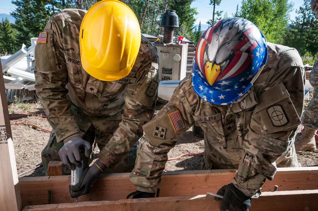U.S. Army Reserve Spc. Alexander Wise, left, and U.S. Army Reserve Spc. Jesus Javalera, right, both interior electricians with the 409th Engineer Company out of Fort Collins, Colorado, construct an archery storage shed at the YMCA of the Rockies - Snow Mountain Ranch, Granby, Colorado, July 20, 2017. (U.S. Army Reserve photo by Spc. Ce Shi, 222nd Broadcast Public Affairs Detachment)