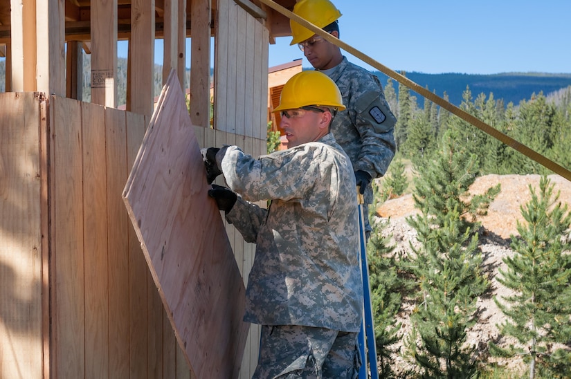 U.S. Army Reserve Spc. Gage Dean, a carpentry and masonry specialist, left, and U.S. Army Reserve Pfc. Edgar Briones, a plumber, at right, from the 994th Engineer Company out of Denver, Colorado, install siding during the construction of a large storage shed at the YMCA of the Rockies - Snow Mountain Ranch, in Granby, Colorado, July 20, 2017. (U.S. Army Reserve photo by Spc. Miguel Alvarez, 354th Mobile Public Affairs Detachment)