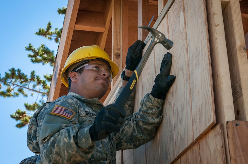 U.S. Army Reserve Pfc. Edgar Briones, a plumber, from the 994th Engineer Company out of Denver, Colorado, installs siding during the construction of a large storage shed at the YMCA of the Rockies-Snow Mountain Ranch, in Granby, Colorado, July 20, 2017. (U.S. Army Reserve photo by Spc. Ce Shi, 222nd Broadcast Public Affairs Detachment)