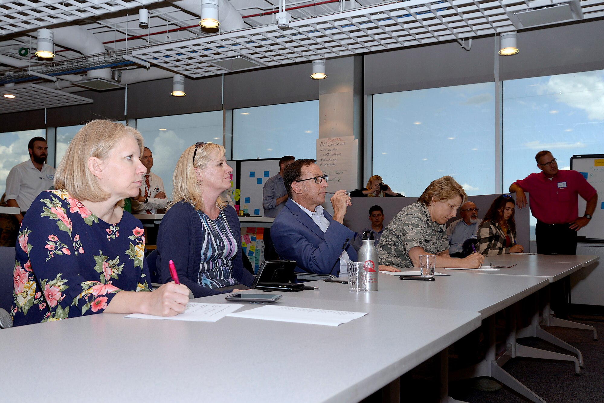 Lt. Gen. Michelle Johnson, the superintendent of the Air Force Academy (right), and Lance Bolton, president of Pikes Peak Community College, take notes during one of four skits presented by IT experts and high school and college students, July 20, 2017, at the CyberWorx Design Sprint at the U.S. Air Force Academy. (U.S. Air Force photo/Darcie Ibidapo 