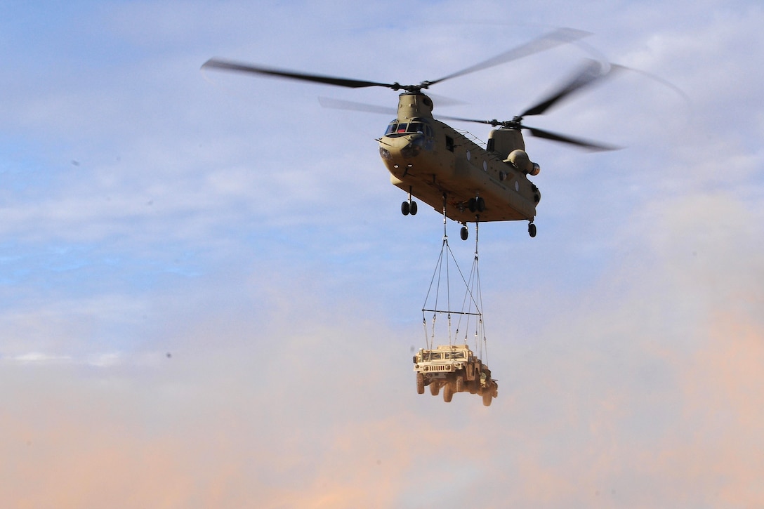 A CH-47 Chinook helicopter prepares to drop off Humvees at a landing zone as part of slingload operations during training at Fort Bliss, Texas, July 23, 2017. Army photo by Pvt. Deomontez Duncan