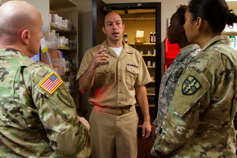 US Public Health Service Lt. Cmdr. Cole Dysinger, a pharmacist at the Verne E. Gibbs Clinic at Poplar, Montana clinic, informs the incoming Soldiers of the 7239th Medical Support Unit, Chattanooga, Tennessee, about the facilities and procedures as they begin their Fort Peck Innovative Readiness Training, July 17, 2017. During the two-week-long mission, medical and dental care will be provided to an estimated population of over 8,000 residents.(U.S. Army Reserve photo by Spc. Claudia Rocha 345th Public Affairs Detachment)